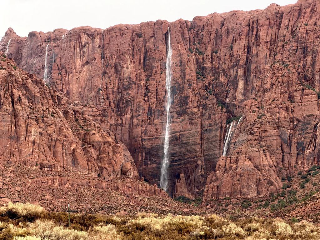 Waterfalls pouring down a red sandstone cliff near Ivins, Utah